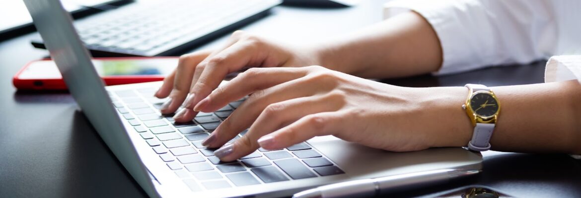 A woman typing on a keyboard