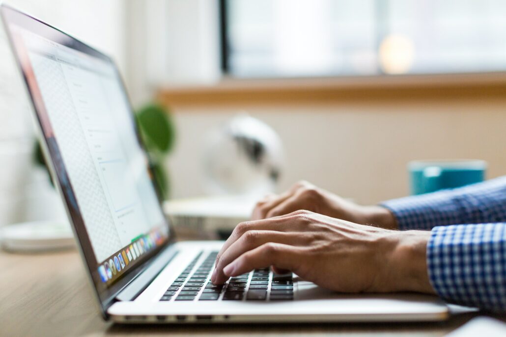 man typing on computer