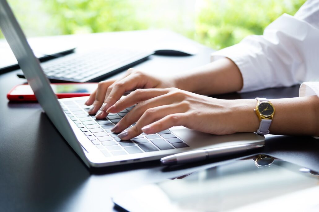 A woman typing on a keyboard